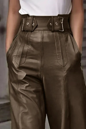 High-waisted brown faux leather pants with belt detail and deep pockets