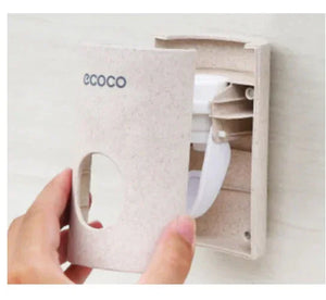 Hand installing beige Ecoco wall-mounted holder for home organization