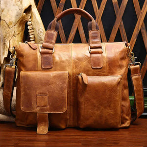Men's vintage brown leather messenger bag with handle and shoulder strap, two front pockets
