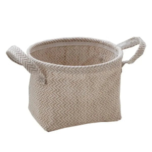 Beige woven storage basket with handles and chevron pattern, home organization decor