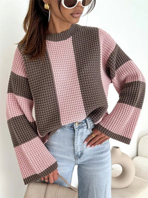 Pink and brown color block knit sweater with light blue jeans and sunglasses — oversized women's sweater