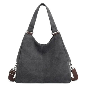 Dark grey canvas tote bag with brown adjustable shoulder straps, minimalist design