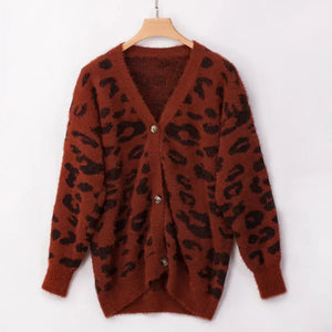 Brown fuzzy cardigan with black animal print and button front, hanging on wooden hanger