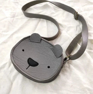 Gray bear-shaped crossbody bag for kids on white fabric background