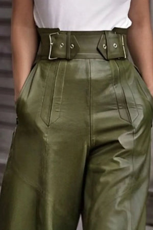 High-waisted olive green wide-leg pants with double belt detail and hands in pockets