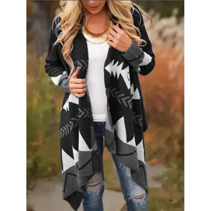 Woman wearing a black and white geometric patterned cardigan, white top, ripped jeans