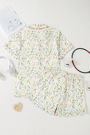 Kids floral short-sleeve pajama set with pink and yellow flowers, displayed flat lay
