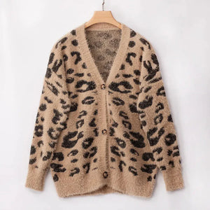 Beige fuzzy cardigan with black leopard print and button-up front on hanger
