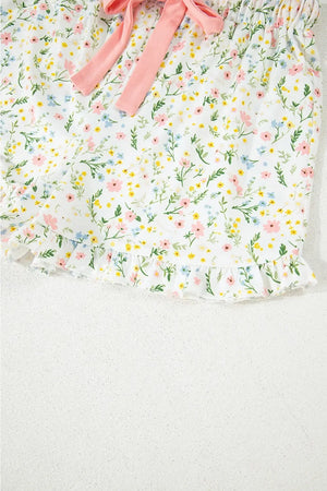 Kids floral print shorts with pink bow and ruffled hem on white background