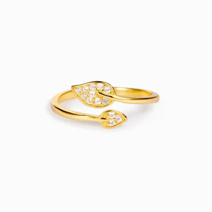 Gold wrap-around leaf ring with clear crystals, elegant jewelry on white background