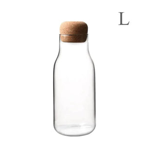 Clear glass storage bottle with cork lid, size large, on white background