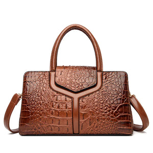 Brown crocodile pattern leather handbag with top handle and detachable shoulder strap