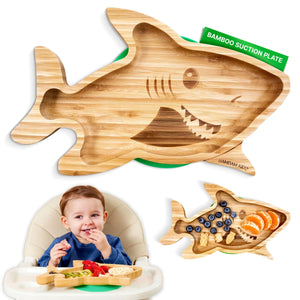 Bamboo shark-shaped suction plate for kids, shown with fruit snacks and a toddler using it.