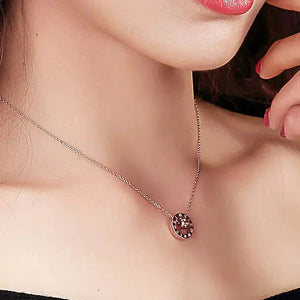 Elegant woman wearing a round pendant necklace, close-up fashion jewelry shot