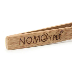 Close-up of wooden tong with NOMOY PET branding, eco-friendly kitchen utensil