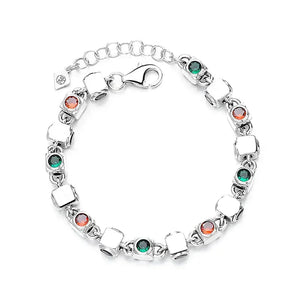 Silver bracelet with red and green gemstones and square links on white background