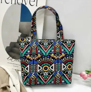 Colorful geometric print tote bag with double handles on a white table