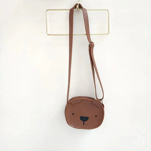 Brown bear face kids crossbody bag with adjustable strap on a white background