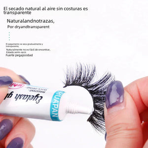 Hand applying eyelash glue to false eyelashes, close-up, with purple manicured nails.