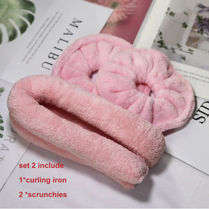 Soft pink heatless curling set with plush curling rod and two matching scrunchies on magazines