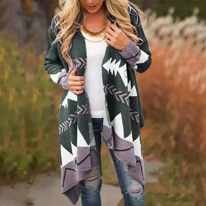 Woman wearing geometric print open-front cardigan with white shirt and ripped jeans outdoors