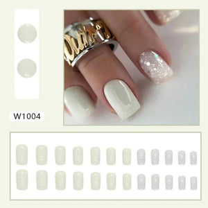Glossy white press on nails with accent glitter nails, displayed on hand and in set layout.