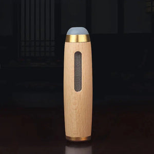 Wooden cylindrical spice grinder with gold accents and mesh window on dark background