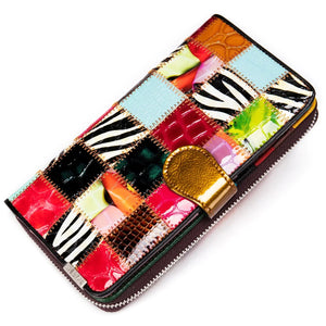 Colorful patchwork leather wallet with animal print and gold snap closure on white background
