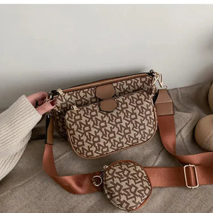 Brown patterned crossbody bag set with adjustable strap and small coin pouch on beige fabric
