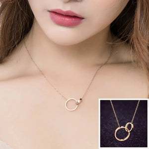 Delicate gold necklace with interlocking circle pendants on a woman's neck