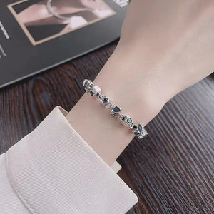Elegant silver gemstone bracelet with black and white stones on wrist
