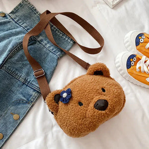 Cute brown teddy bear crossbody bag for kids with blue flower detail, denim skirt, yellow sneakers