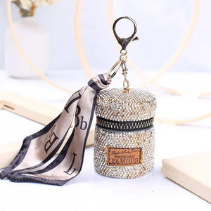 Rhinestone mini cylindrical handbag with zipper, keychain clasp, and attached patterned scarf.