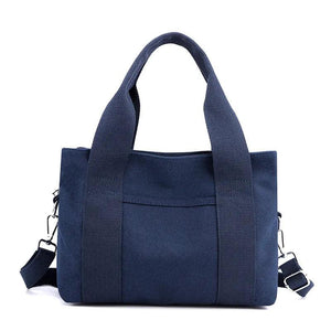 Navy blue canvas tote bag with wide handles and detachable shoulder strap
