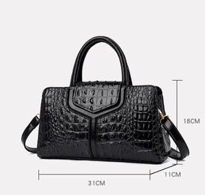 Black crocodile pattern leather handbag with double handles, shoulder strap, and size measurements