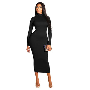Woman wearing a black long sleeve bodycon midi dress with high neckline, holding a clutch.