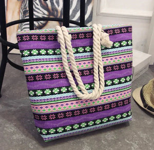 Colorful boho tote bag with purple, green, and pink geometric patterns and thick rope handles