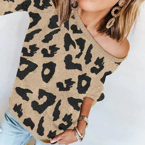 Woman wearing off-shoulder leopard print sweater with statement earrings and bracelets