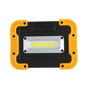 Portable LED work light with rugged black and yellow casing, front view