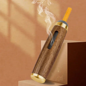 Wood and gold smoking pipe with filter, emitting smoke, on a beige background.