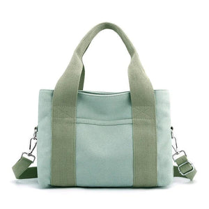 Light green canvas tote bag with top handles and detachable shoulder strap