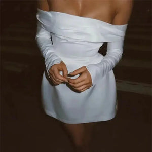 Woman wearing off shoulder white mini dress with long sleeves, evening fashion look