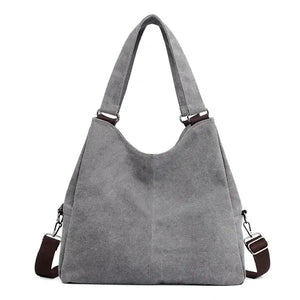 Stylish gray canvas tote bag with dual handles and detachable shoulder strap