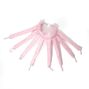 Soft pink heatless hair curler with multiple rods and loops on a white background