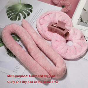 Pink heatless hair curler set with claw clip and soft scrunchies on a flat lay background