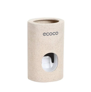 Beige cylindrical toothbrush holder with Ecoco logo and a visible toothpaste dispenser