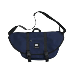 Navy blue messenger bag with black straps and adjustable shoulder strap, front logo patch