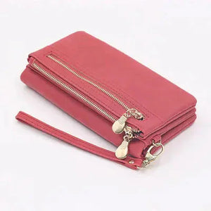 Pink leather wallet with wrist strap, gold zippers and multiple compartments