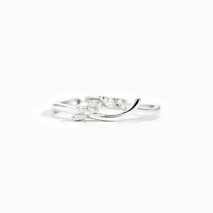 Silver minimalist ring with leaf-shaped clear stones on white background