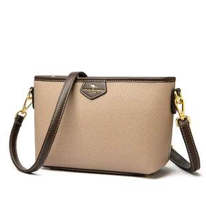 Beige and brown leather crossbody bag with gold hardware and detachable strap